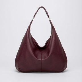 Bolsa de ombro grande Hermione Mayzê. Modelo hobo maxi em couro ecológico, fechamento em zíper e bolso interno. Elegante para trabalho e dia a dia.