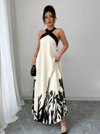Vestido longo Lien Mayzê com costas abertas e laço. Elegante, fluido e perfeito para casamentos, festas e jantares especiais.