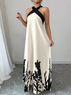 Vestido longo Lien Mayzê com costas abertas e laço. Elegante, fluido e perfeito para casamentos, festas e jantares especiais.