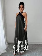 Vestido longo Lien Mayzê com costas abertas e laço. Elegante, fluido e perfeito para casamentos, festas e jantares especiais.