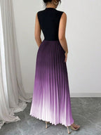 Vestido maxi degradê plissado Doux Mayzê. Saia plissada em A, cintura alta e caimento elegante para festas e eventos noturnos.