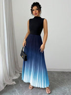 Vestido maxi degradê plissado Doux Mayzê. Saia plissada em A, cintura alta e caimento elegante para festas e eventos noturnos.